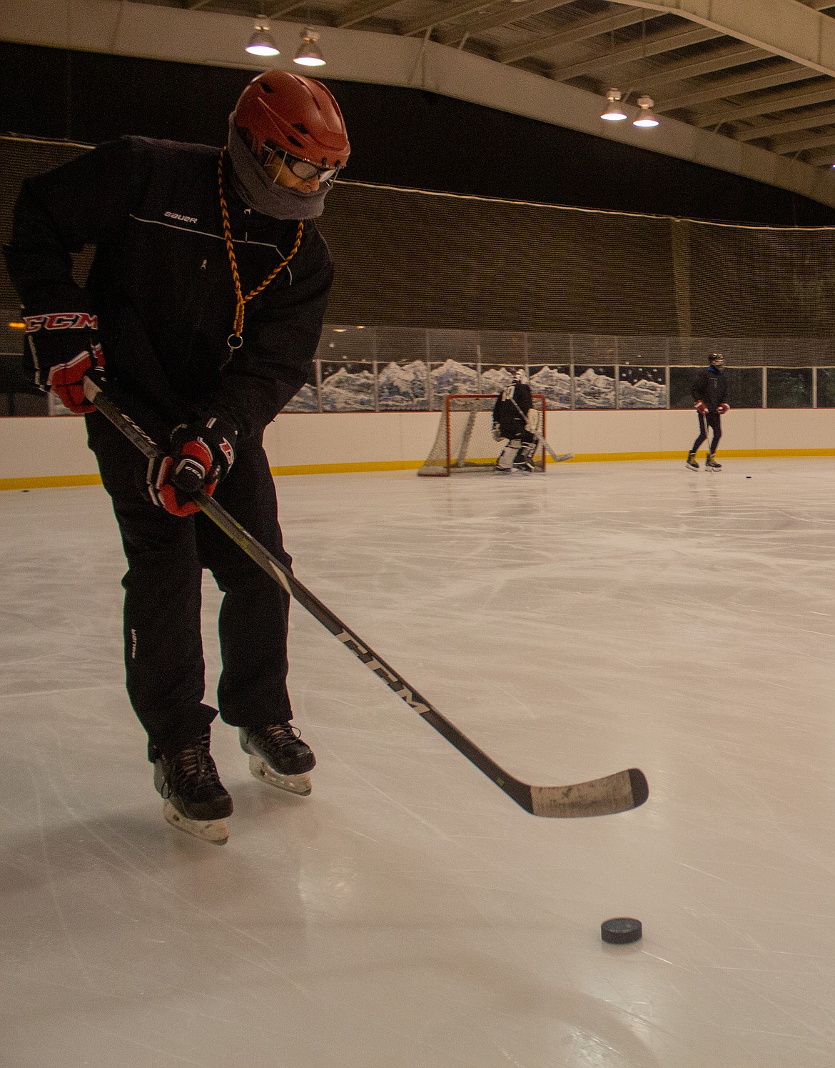 18U coach and MLYHA Hockey Director Chad Strevy works with his team on the ice as they get warmed up at the beginning of practice on Monday night.