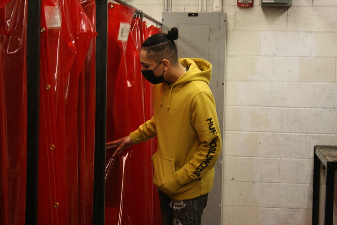 Cyril Mendoza takes a look at the booths in the welding shop at Othello High School. District officials recently added more graduation options for students in the career and technical education curriculum, which includes classes like welding.