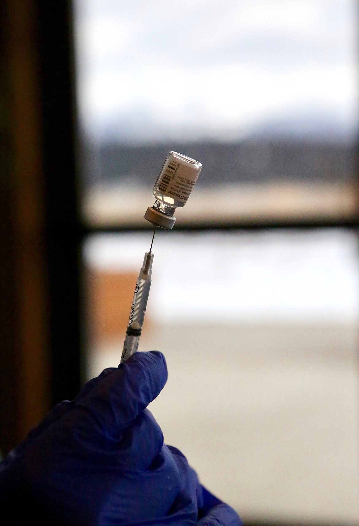 Pharmacist Vince Stone prepares a dose of the Pfizer-BioNTech COVID-19 vaccine to administer to staff of Rising Mountains Assisted Living in Bigfork.
Mackenzie Reiss/Bigfork Eagle