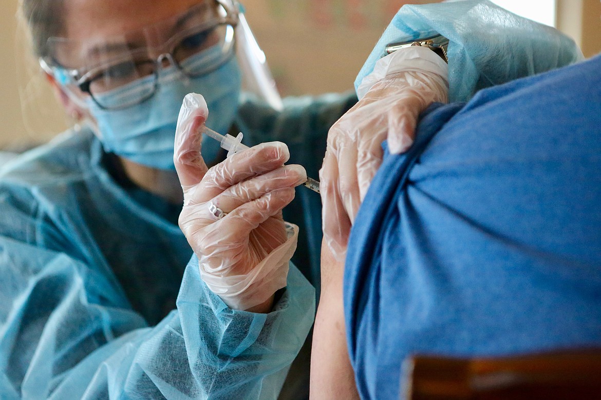 Dana Bimler, a CVS pharmacy intern, administers the COVID-19 vaccine to an employee at Rising Mountains Assisted Living. About half of the staff members and residents received the vaccine Friday, Jan. 22, which was voluntary.