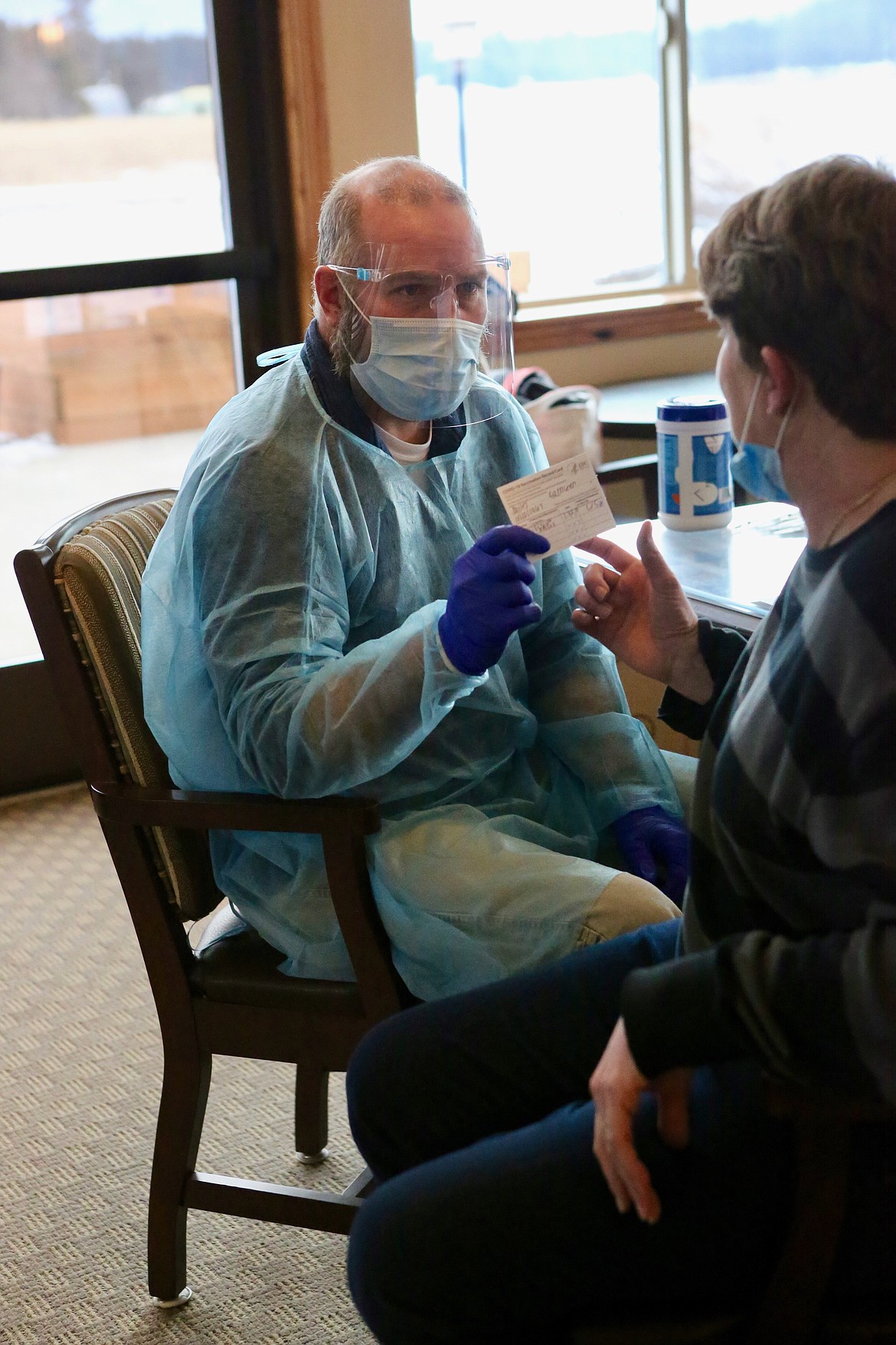 Kathleen Miles, a med tech/certified nursing assistant receives a COVID-19 vaccine record card after receiving the first dose of the Pfizer-BioNTech vaccine Friday, Jan. 22.
Mackenzie Reiss/Bigfork Eagle