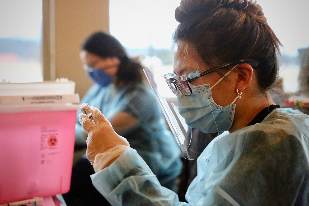 Dana Bimler, a CVS pharmacy intern, prepares a dose of the Pfizer-BioNTech COVID-19 vaccine at Rising Mountains Assisted Living on Friday, Jan. 22.
Mackenzie Reiss/Bigfork Eagle