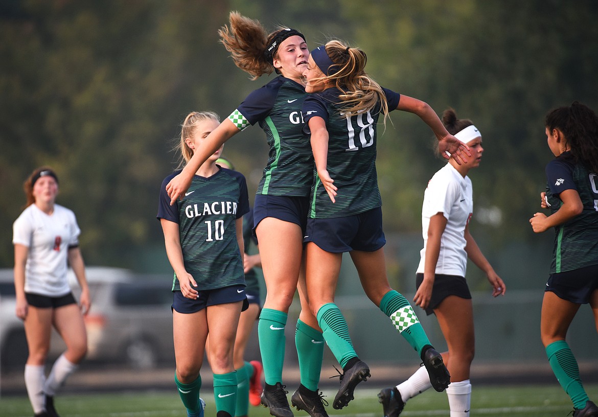 Glacier's Kenzie Williams (12) celebrates with Madison Becker (18) after Becker's first-half goal against Flathead during crosstown soccer at Legends Stadium on Tuesday, Sept. 15, 2020. (Casey Kreider/Daily Inter Lake)