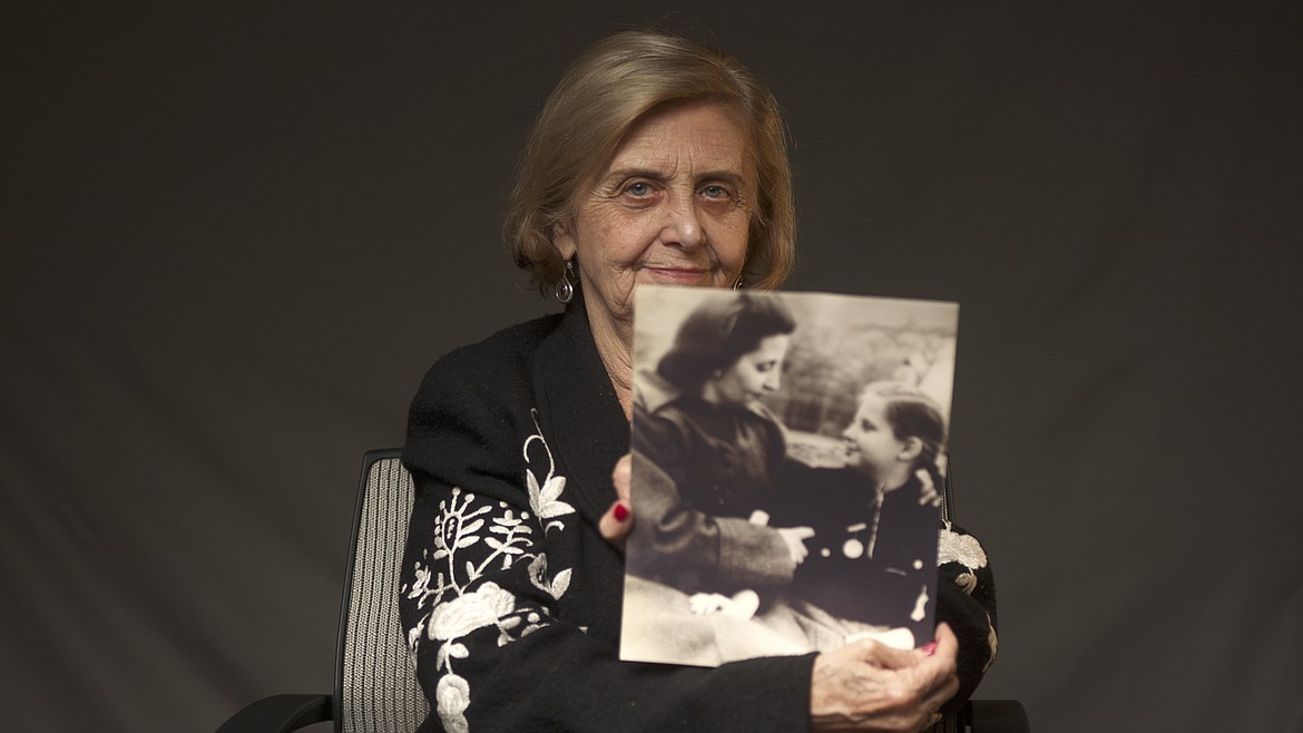 This photo provided by the World Jewish Congress, shows Tova Friedman, an 82-year-old Polish-born Holocaust survivor holding a photograph of herself as a child with her mother, who also survived the Nazi death camp Auschwitz, in New York, Friday, Dec.13, 2019. Friedman is delivering a warning against rising hatred in the world during an online commemoration on Wednesday, the 76th anniversary of the liberation of Auschwitz by Soviet troops at end of World War II. The commemorations for the victims of the Holocaust at the International Holocaust Remembrance Day, marking the liberation of Auschwitz-Birkenau on Jan. 27, 1945, will be mostly online in 2021 due to the coronavirus pandemic.