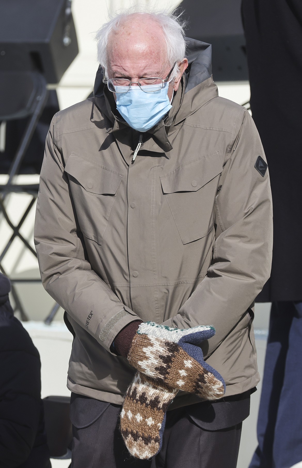 In this Jan. 20, 2021 file photo, Sen. Bernie Sanders, I-Vt., wears mittens as he attends President Joe Biden's inauguration ceremony at the U.S. Capitol in Washington. Sanders says the wooly mittens he wore to the ceremony that sparked endless quirky memes across social media have helped to raise $1.8 million in the last five days for charitable organizations in his home state of Vermont through the sale of T-shirts, sweatshirts and stickers with the iconic image of him sitting with his arms and legs crossed in his brown parka and recycled wool mittens