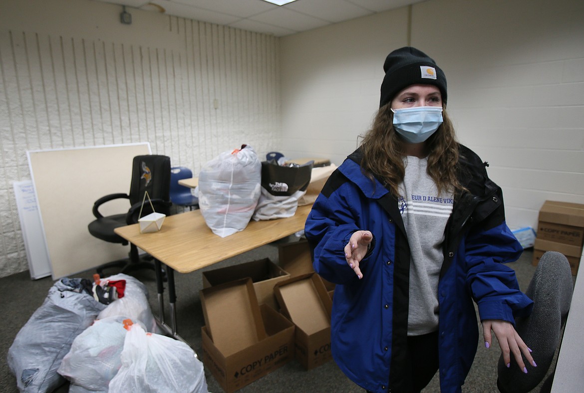 Coeur d'Alene High School ASB President Holly Hudson stands among bags and boxes of donations on Wednesday as she shares details about the successful All for AWL campaign working with Lake City High to serve the community this month in lieu of the Fight for the Fish spirit competition.