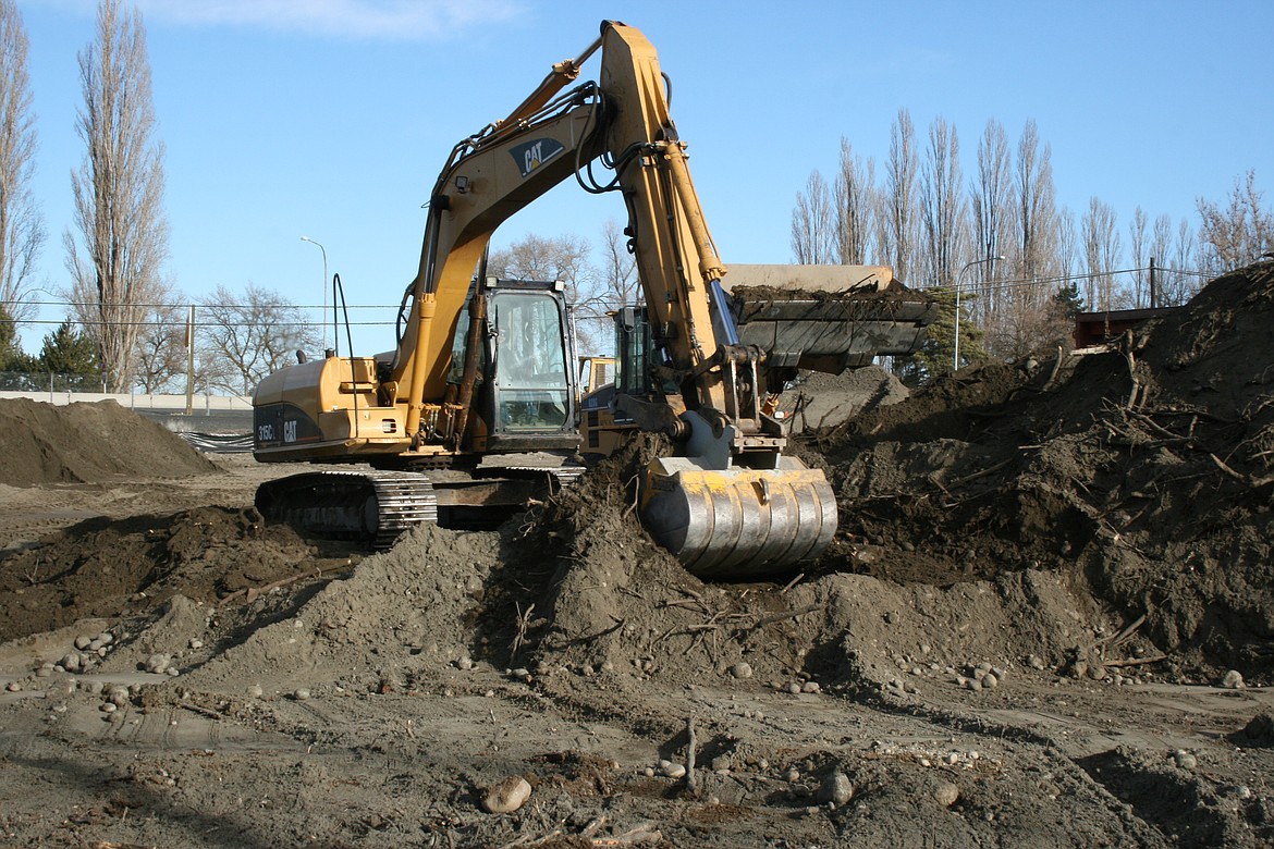 A power shovel takes a bite out of a site of a new wetland at the Love's Travel Stop location in Moses Lake.