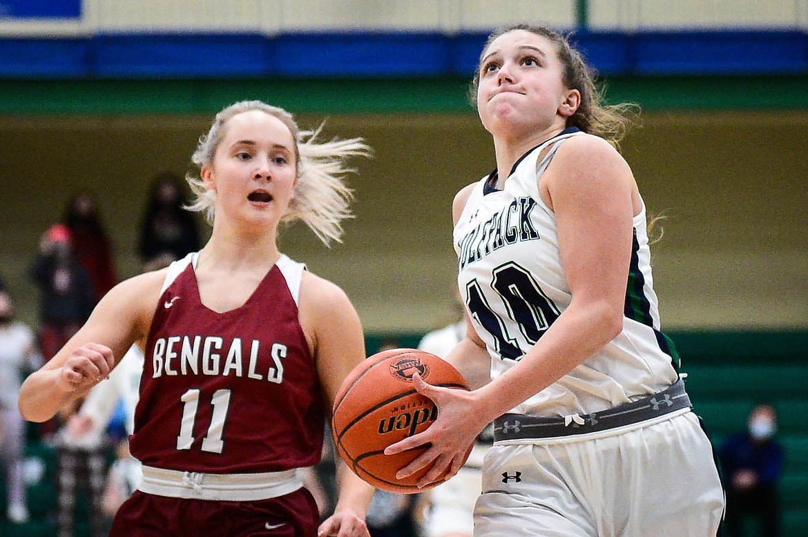 Glacier's Bethany Sorensen (10) drives to the basket after stealing the ball from Helena's Brooke Ark (11) at Glacier High School on Thursday. (Casey Kreider/Daily Inter Lake)