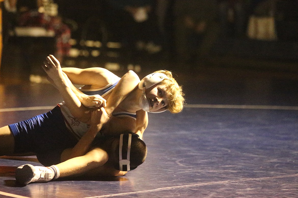 JASON ELLIOTT/Press
Coeur d'Alene freshman Boston Spear looks to assistant coach Tony Hook during the second period a 113-pound match at Lake City High on Thursday.