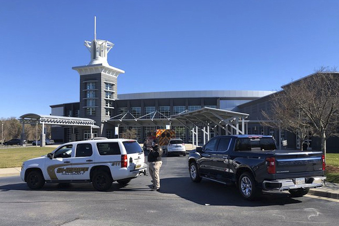 A Hall County Sheriff guards the entrance to the campus of Free Chapel, a church where about 130 workers were taken by bus to be examined for injuries following a liquid nitrogen leak at nearby Prime Pak Foods in Gainesville, Ga. A liquid nitrogen leak at the northeast Georgia poultry plant killed six people Thursday, with multiple others taken to the hospital, officials said.