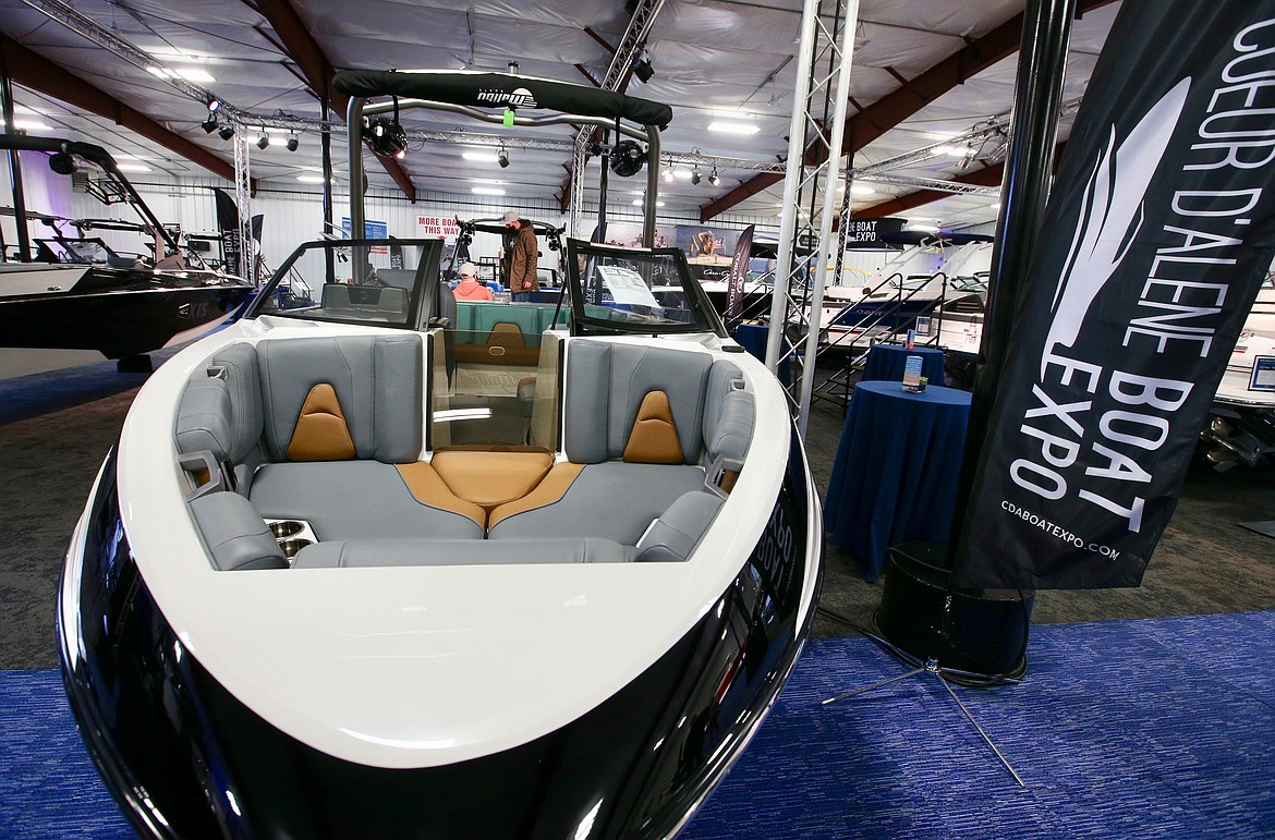 Visitors to the Coeur d'Alene Boat Expo look over the boats on display Thursday at the Hagadone Marine Center.