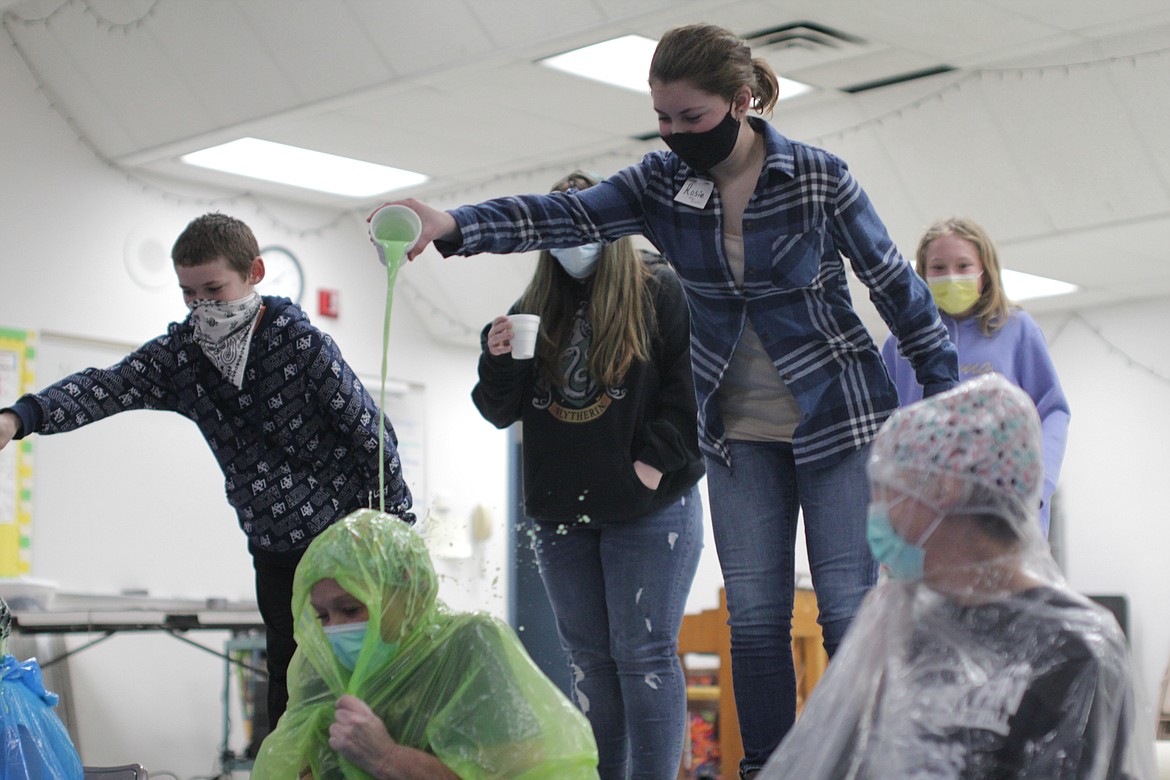 A student dumps slime on sixth-grade teacher Wilma Hahn Thursday at Idaho Hill Elementary.