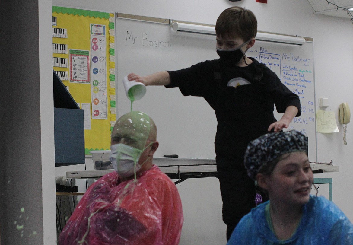 A student pours slime on Bob Selle Thursday afternoon at Idaho Hill Elementary.