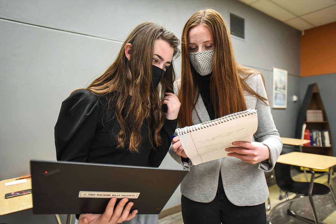 Flathead High School juniors Scout McMahon, left, and Leah Spangler review their extemporaneous speech structures during a break in the state Class AA Speech Tournament on Friday, Jan. 29. (Casey Kreider/Daily Inter Lake)