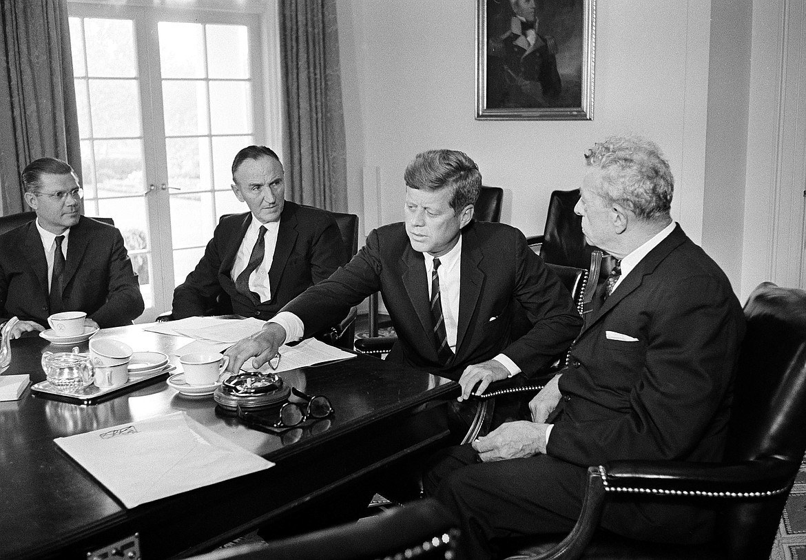 President John F. Kennedy pushes away his coffee cup as he meets in the White House cabinet room with the Senate's leaders, Mike Mansfield (D-Montana), left, and Everett Dirksen (R-Ill.), Sept. 9, 1963. The two were there to discuss ratification of the limited nuclear test ban treaty.(AP Photo/William J. Smith)