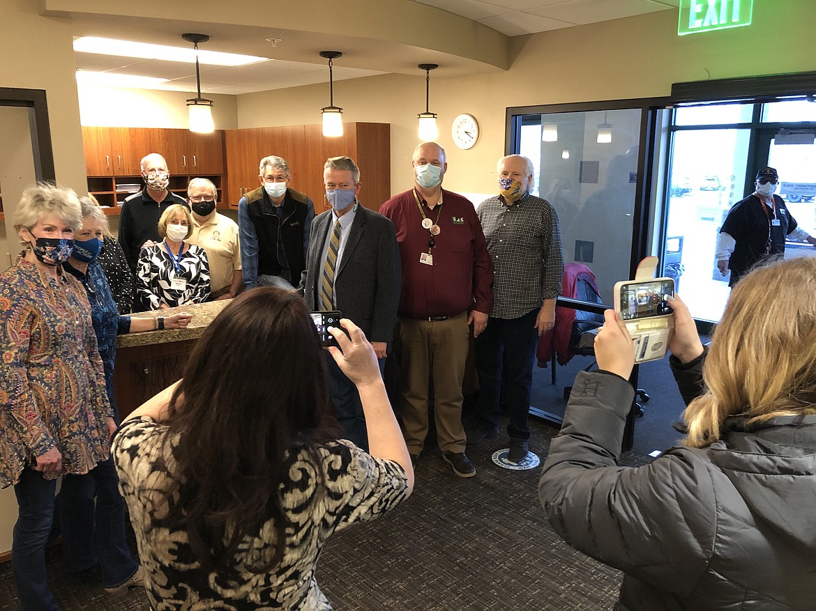 Surrounded by Rotary Club volunteers, Gov. Brad Little (center), Northwest Specialty Hospital CEO Rick Rasmussen (red shirt) and Dr. Jack Riggs, a former Idaho lieutenant governor, pose for photos during the governor's visit Friday afternoon.
MIKE PATRICK/Press