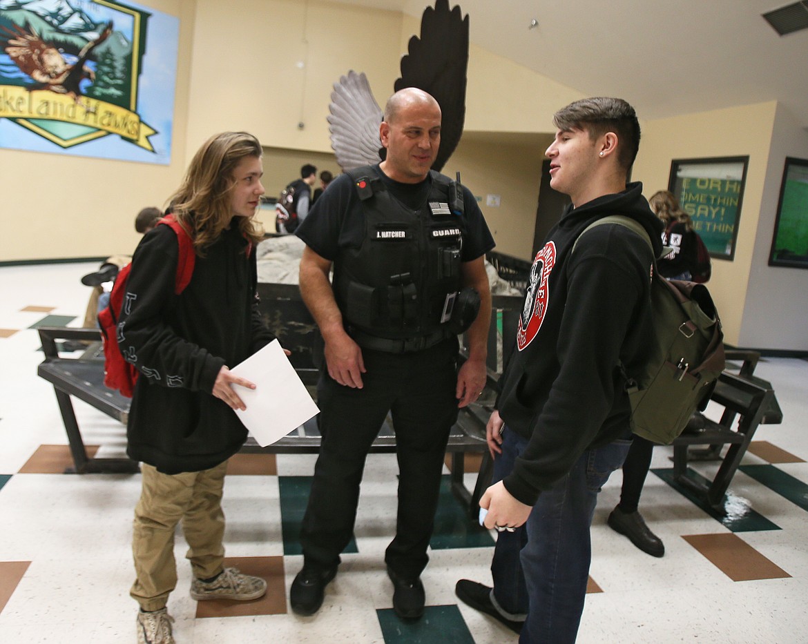 Lakeland Senior High School armed guard John Hatcher checks in with sophomore Evan Egelund, left, and junior Tyler Snyder between classes on Thursday. Lakeland Joint School District has three armed guards with a goal to hire one more. These positions are supported by supplemental/instructional levy funds.