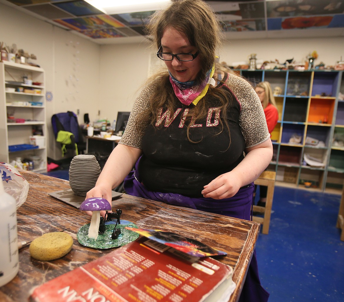 Lakeland Senior High School junior Amber Martin on Thursday shows off a scene of toadstools and black cats she created in Alisia Cannon's pottery class. Art classes and other creative extracurricular activities in the district are supported by supplemental/instructional levy funds. The next Lakeland levy election is March 9.