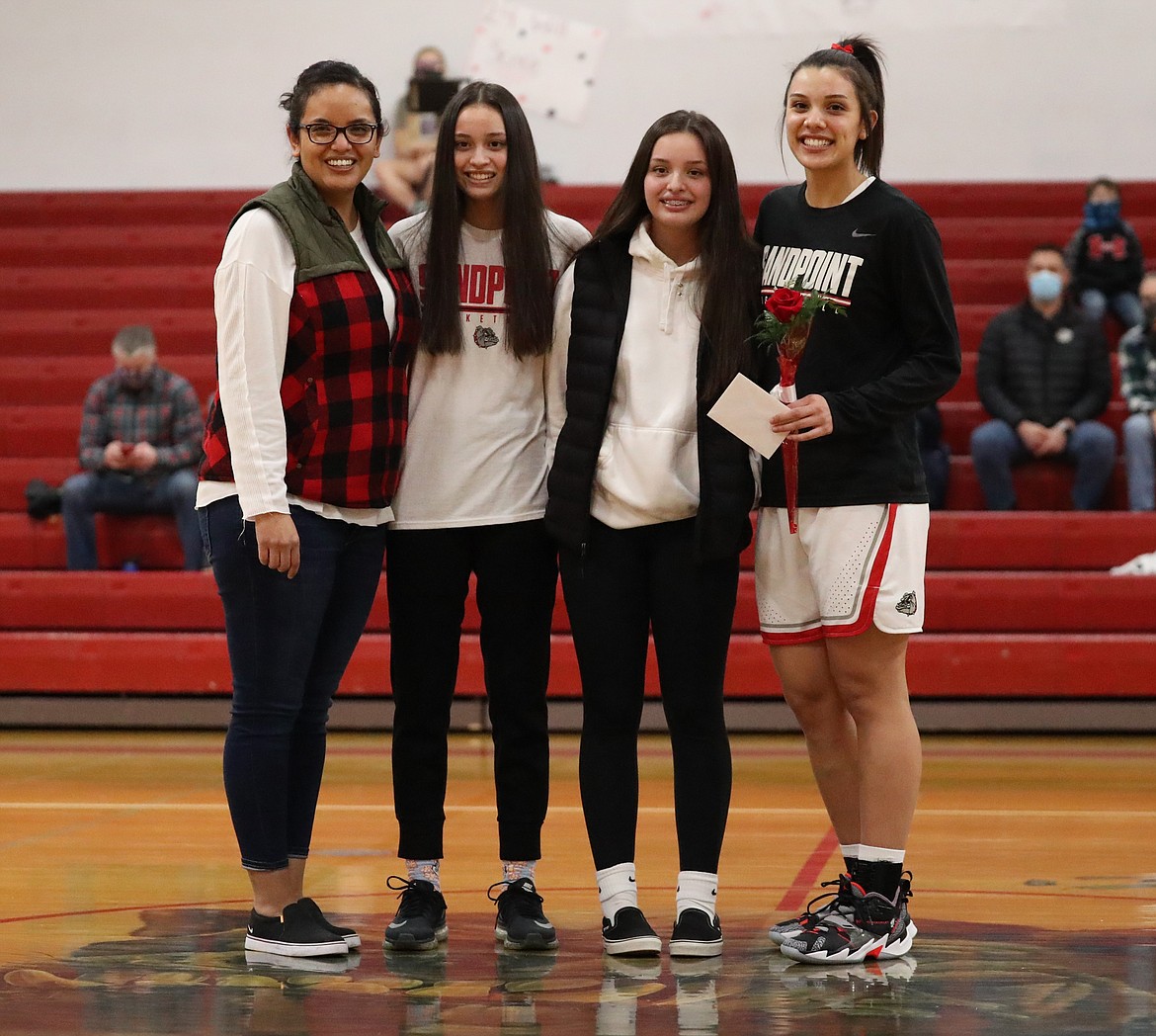 Bella Phillips poses for a photo with her family on Senior Night.