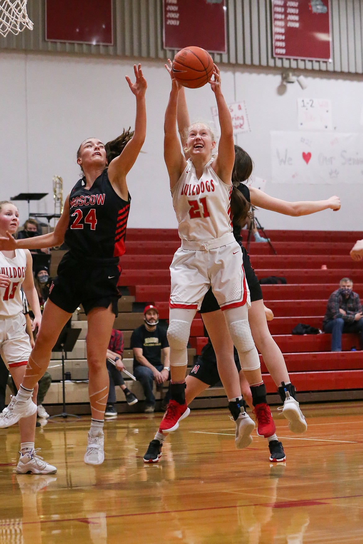 Senior Hattie Larson (right) secures a rebound on Saturday.