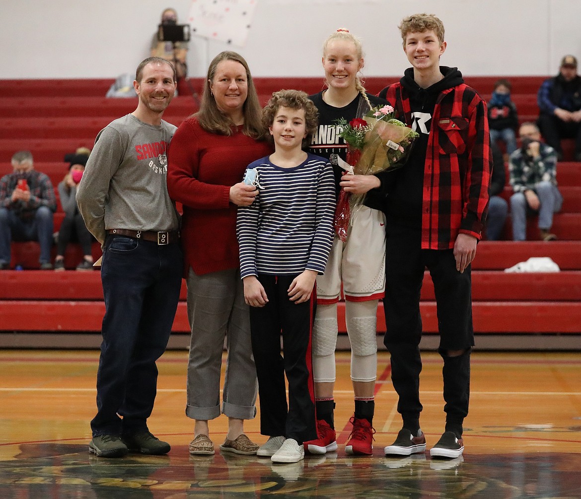 Hattie Larson poses for a photo with her family on Senior Night.