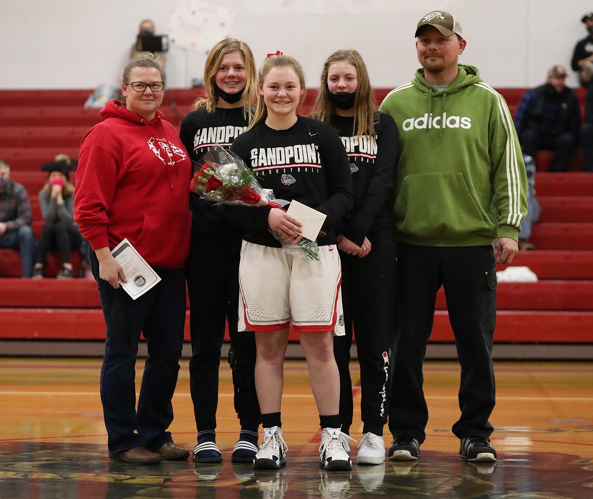 Riley Cessna poses for a photo with her family on Senior Night.