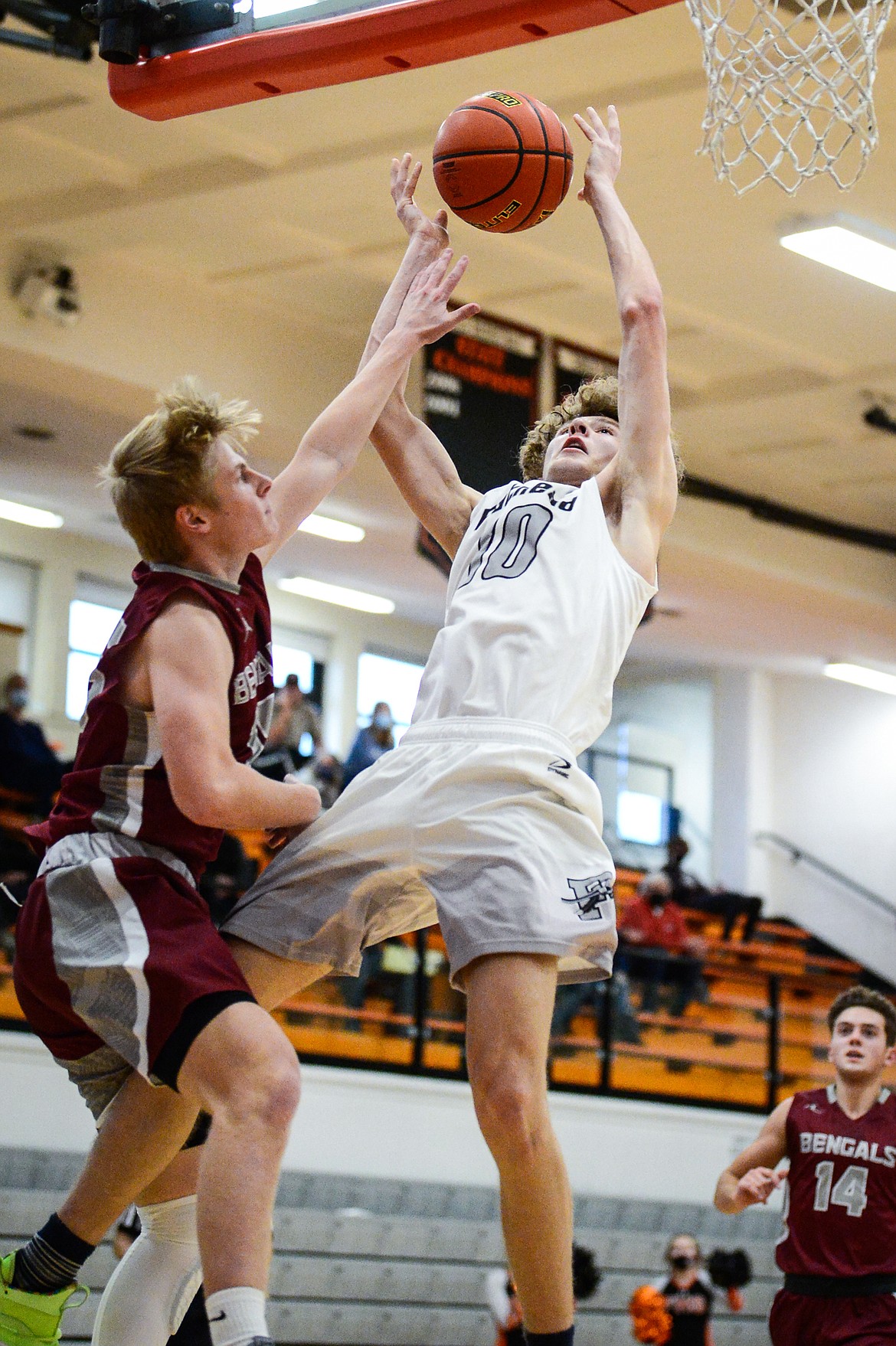 Flathead's Hunter Hickey (10) draws a foul on his way to the hoop against Helena's Kade Schlepp (15) at Flathead High School on Saturday. (Casey Kreider/Daily Inter Lake)