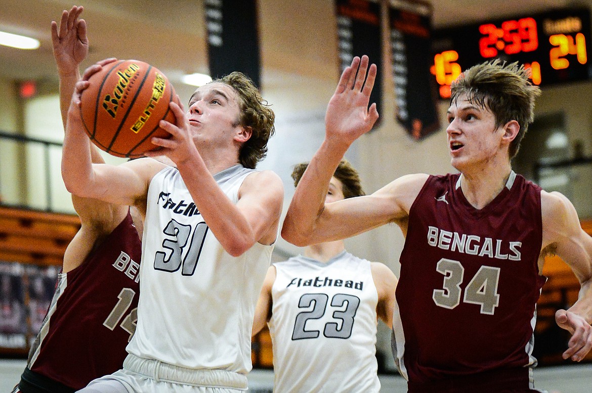 Flathead's Gavin Chouinard (31) drives to the basket against Helena at Flathead High School on Saturday. (Casey Kreider/Daily Inter Lake)