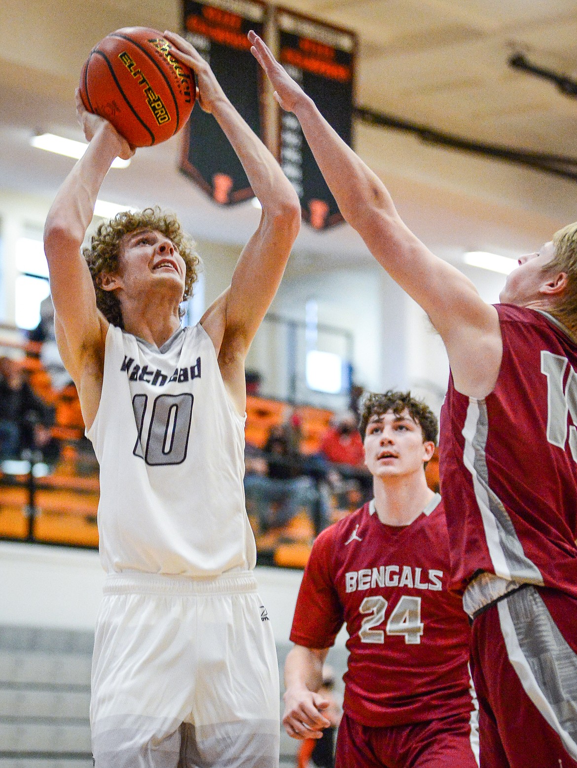 Flathead's Hunter Hickey (10) looks to shoot over Helena's Kade Schlepp (15) at Flathead High School on Saturday. (Casey Kreider/Daily Inter Lake)