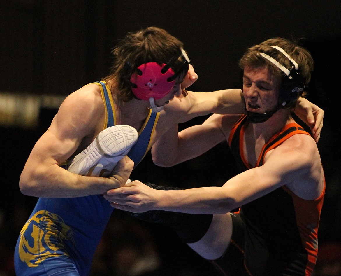 JASON ELLIOTT/Press
Post Falls senior Avery McSpadden attempts to wiggle his foot out of the grasp of Caldwell sophomore Hunter Bidelman during the 126-pound championship match at the North Idaho Rumble at Coeur d'Alene High. Bidelman pinned McSpadden in the first period.