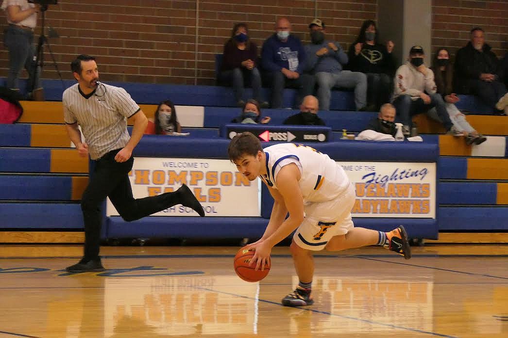 Thompson Falls guard Nathan Schraeder gathers a loose ball as he prepares to head down court against Anaconda Saturday. (Chuck Bandel/Valley Press)