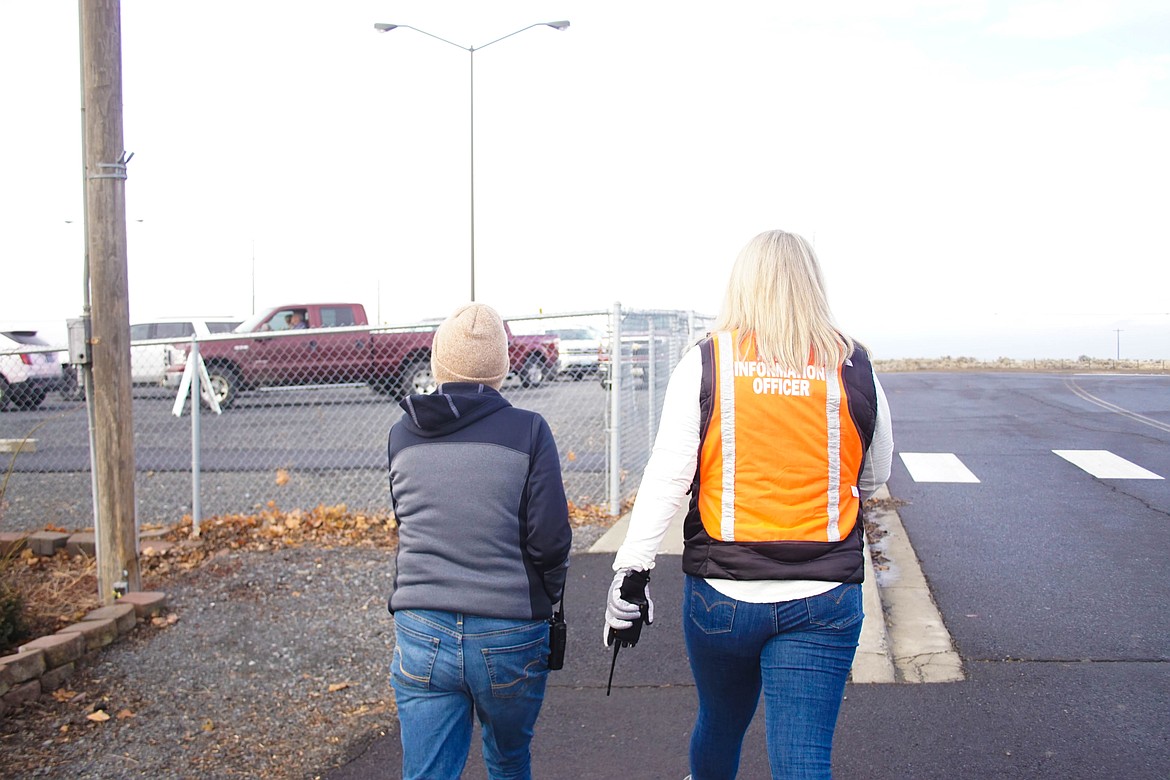 Grant County Health District administrator Theresa Adkinson and Samaritan executive director of communication Gretchen Youngren walking through the vaccination site at the Grant County Fairgrounds on Saturday.