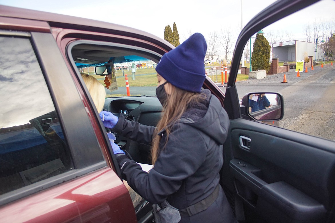 Medical assistant Elizabeth Cedillo administering the COVID-19 vaccine at the Grant County Fairgrounds on Saturday.