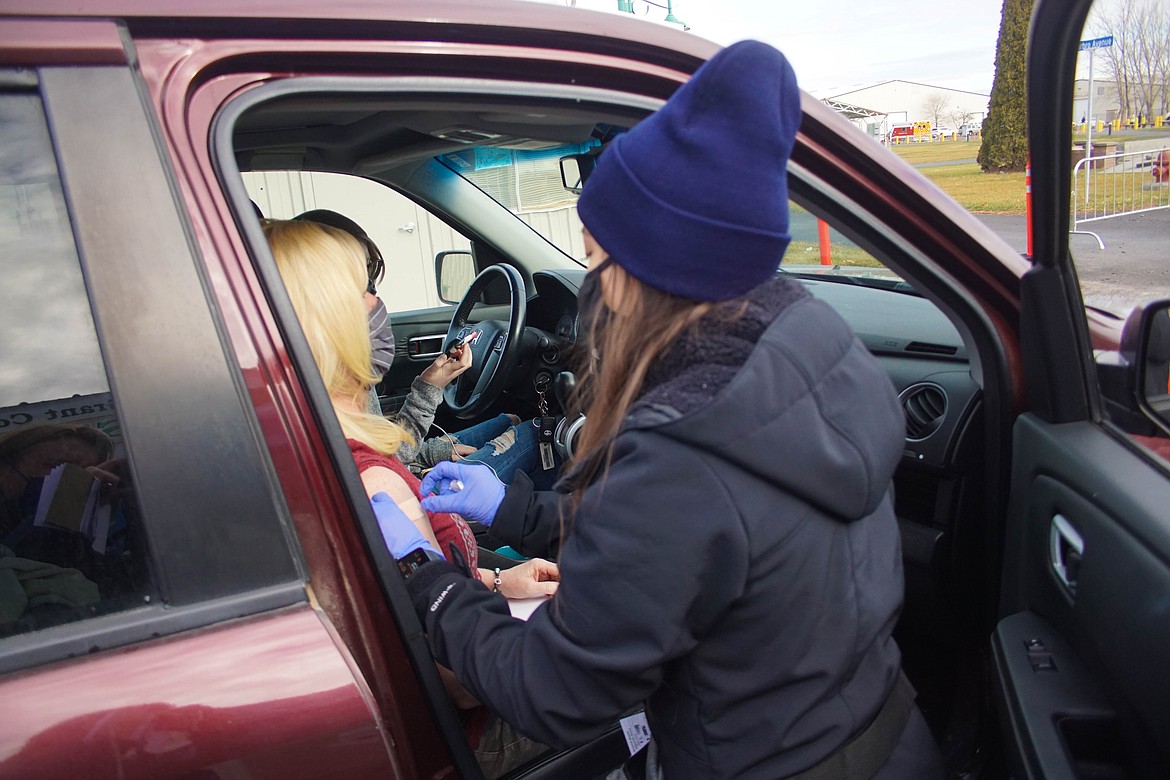 Medical assistant Elizabeth Cedillo administering the COVID-19 vaccine at the Grant County Fairgrounds on Saturday.