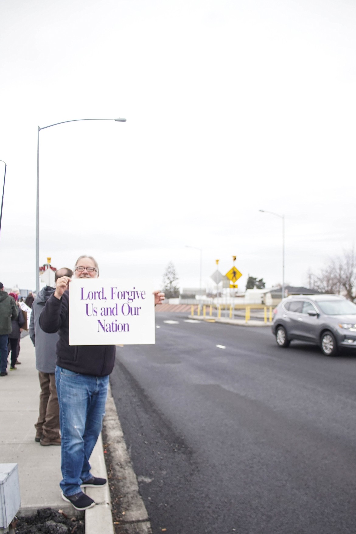 Moses Lake resident Jon Freese holds a sign at the pro life rally on Sunday.