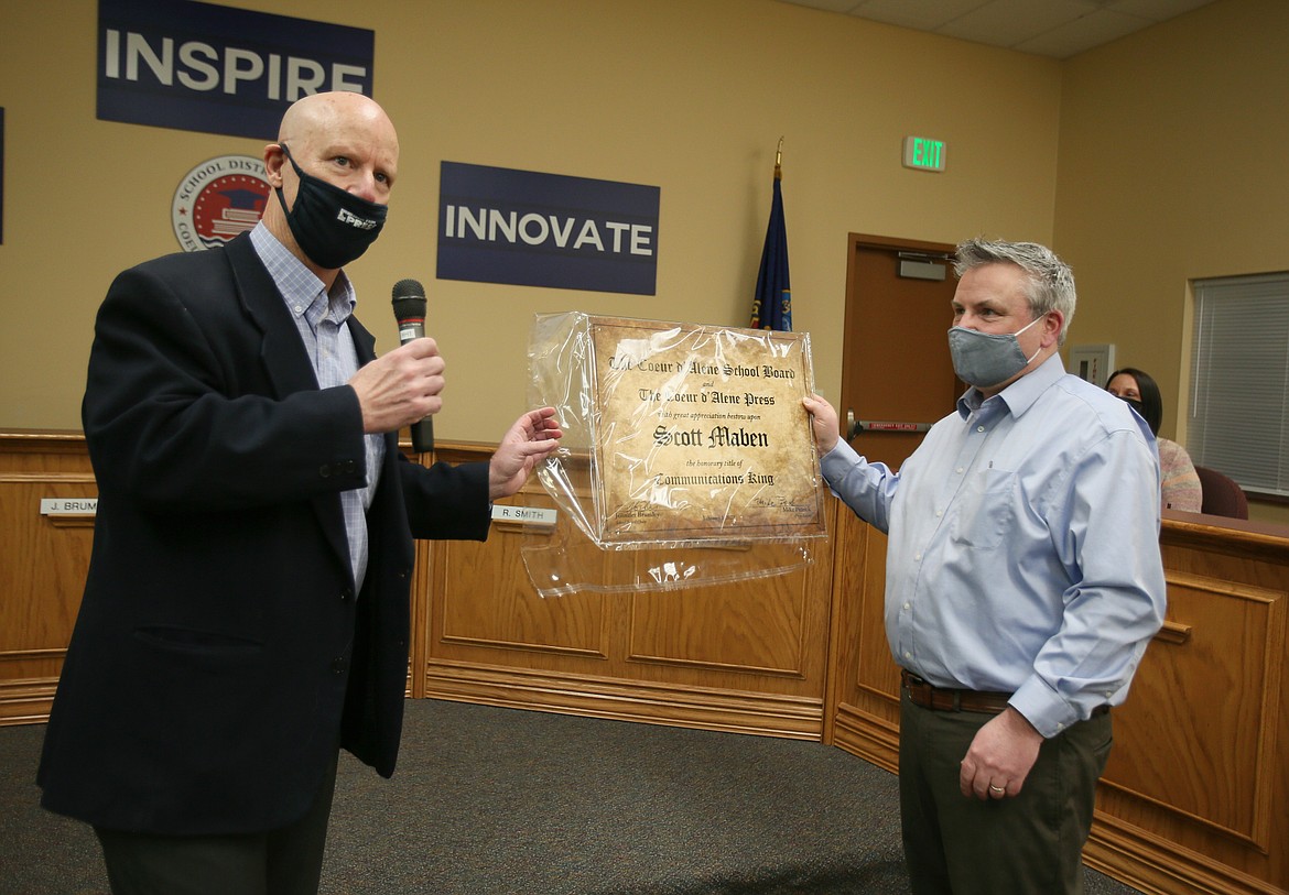 Coeur d'Alene Press Managing Editor Mike Patrick, left, surprises Coeur d'Alene School District communications director Scott Maben with a "Communications King" plaque during the school board meeting Monday. Patrick, Superintendent Steve Cook and board trustees all wanted to do something special for the hard-working Maben to recognize his loyalty, professionalism and overall awesomeness to work with, especially through the tough year brought on by COVID.