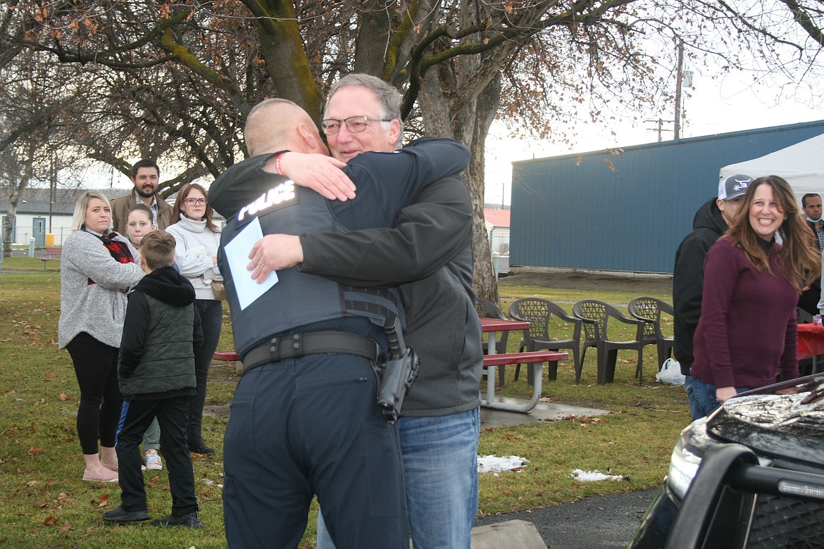Retiring Royal City police chief Darin Smith (right) gets a retirement hug from Moses Lake Police Department Captain Dave Sands.
