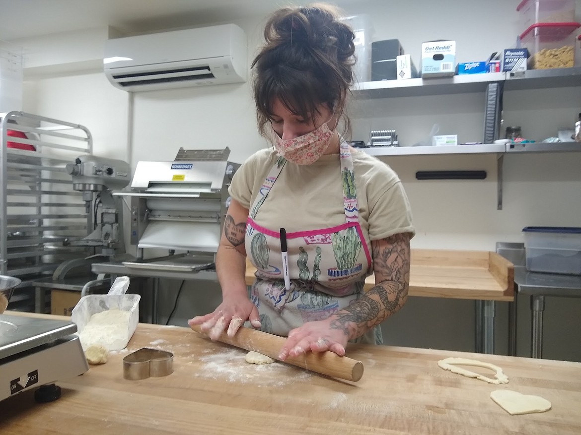 Bakery manager Kendall Fetzer rolls out dough for Valentine's Day-themed treats to be sold at Bean & Pie.