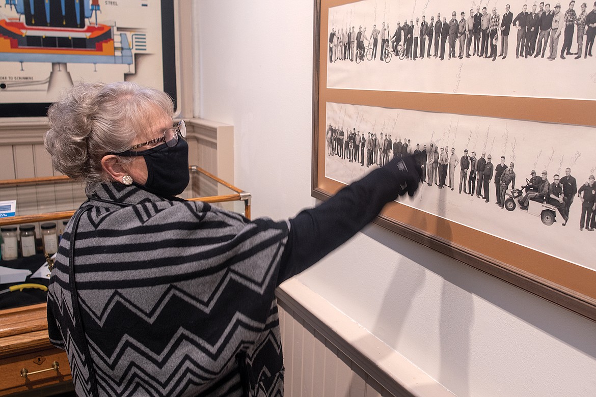 Peg Sorenson talks about the 25th year reunion photo at the CFAC display. (Chris Peterson photo)