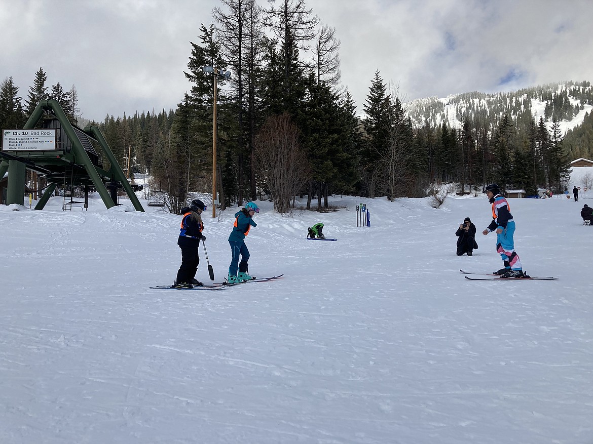 Kirby Heyborne, right, assists 11-year-old adaptive skier Kate Cooke on Big Mountain.