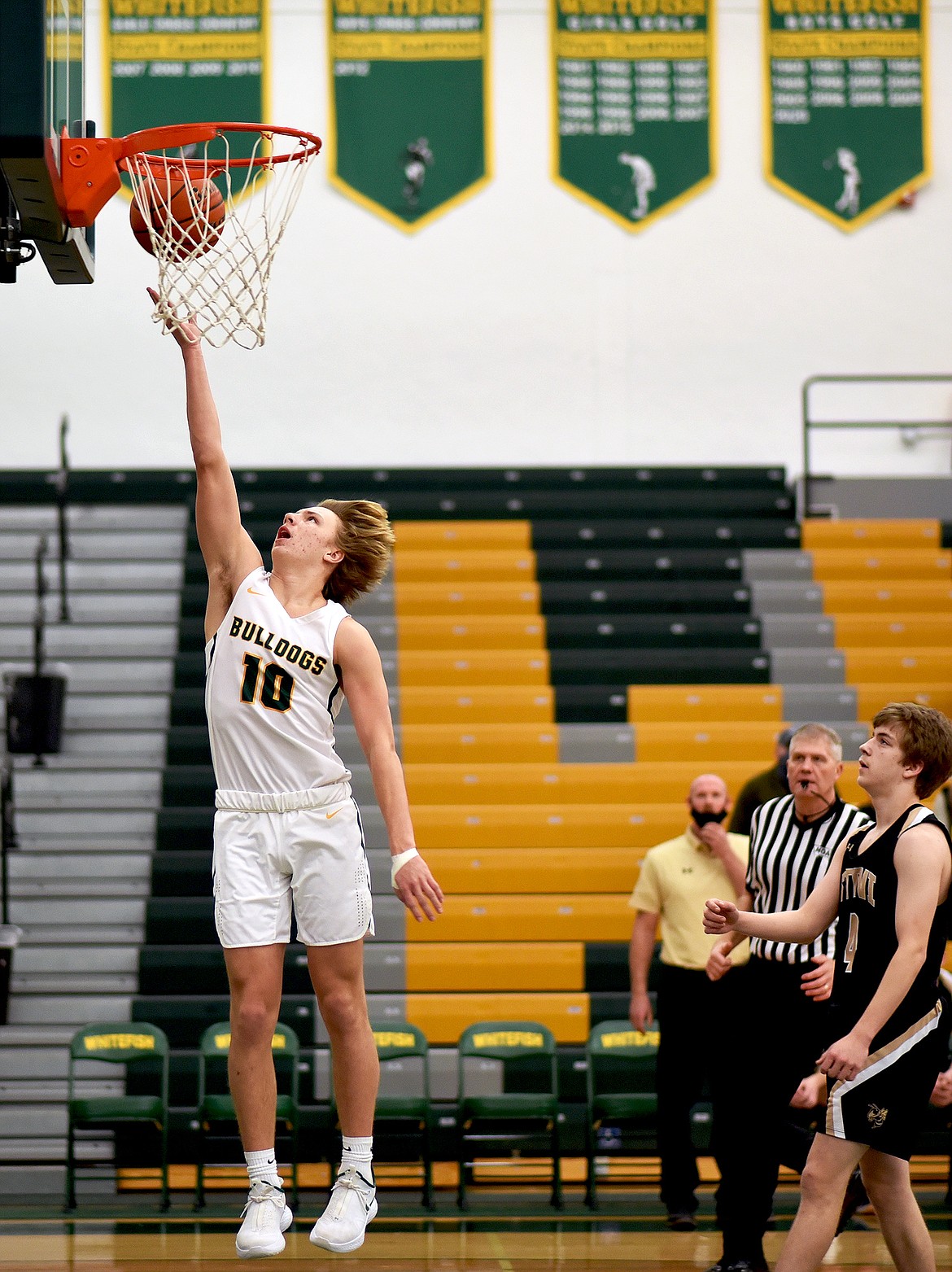 Bulldog Jaxsen Schlauch gets a steal and a fastbreak bucket against Stevensville on Friday. (Whitney England/Whitefish Pilot)