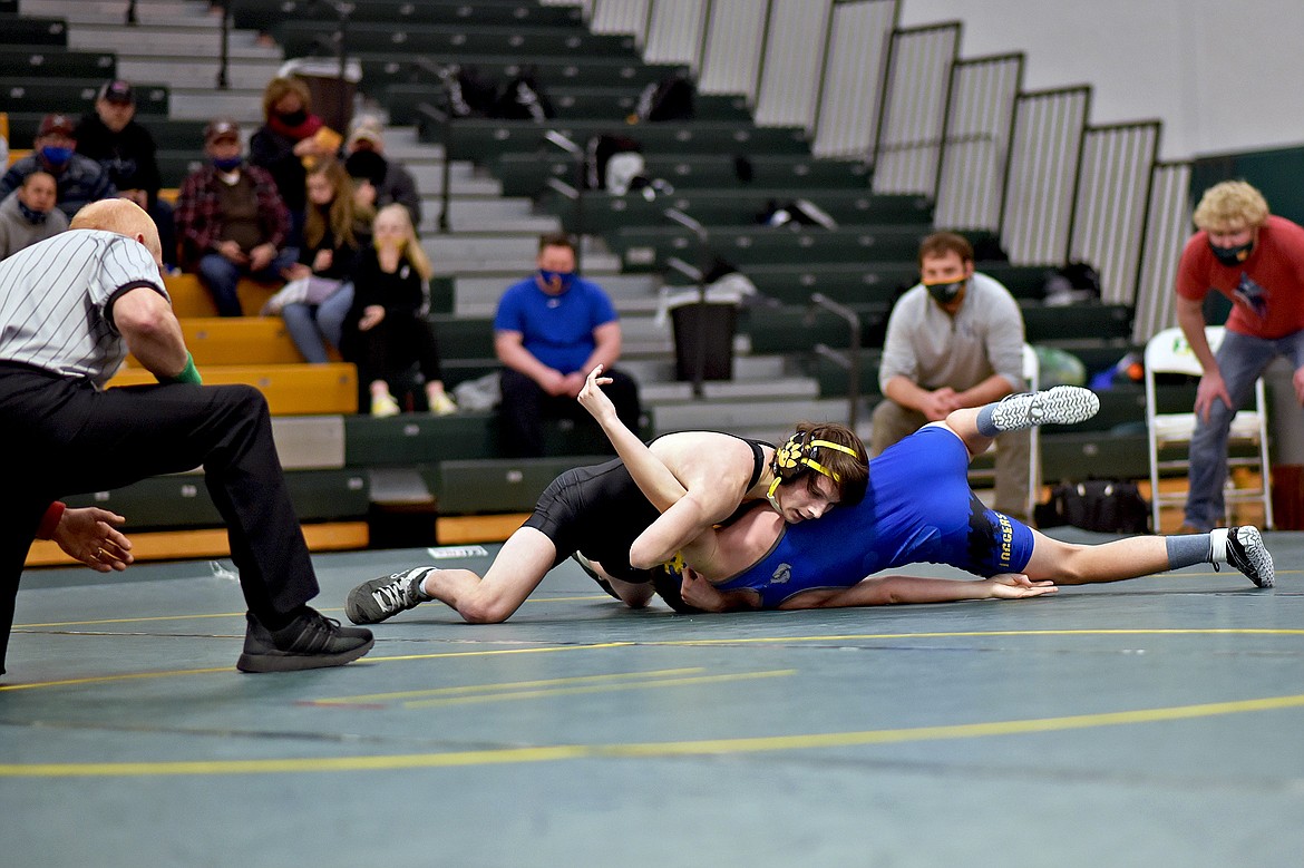 Whitefish's Nathan Sproul works toward pinning Libby's Xavier Reatz on Saturday at Whitefish High School. (Whitney England/Whitefish Pilot)