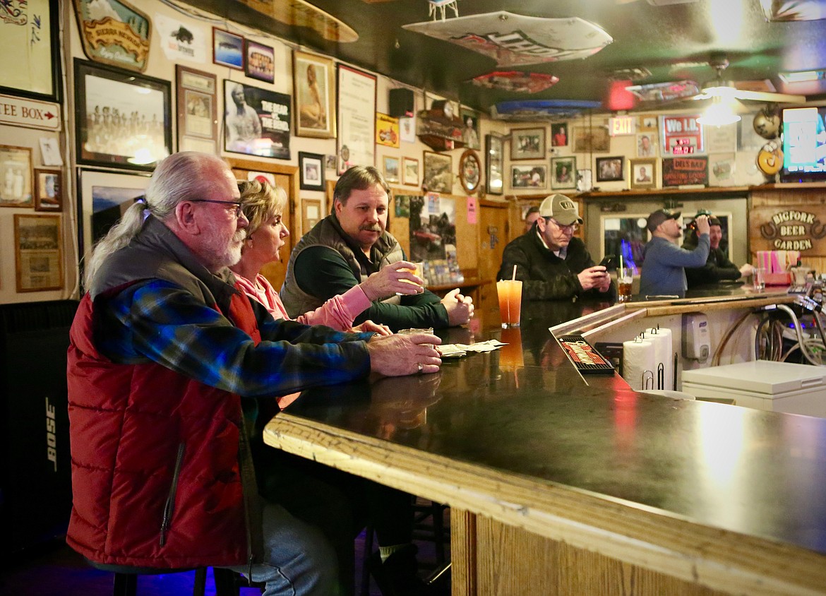 Patrons enjoy an after-work drink at The Garden Bar on Monday night. Roughly a dozen people milled about the bar, which is now able to stay open until 2 a.m. at 100% capacity.
Mackenzie Reiss/Bigfork Eagle