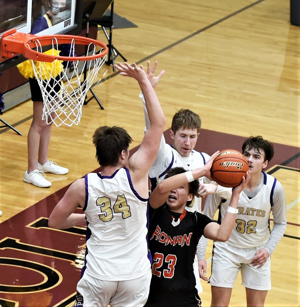 The Chiefs' Leoard Burke looks for a shot against Polson's Trevor Lake (34), Colton Graham (32) and Sam Fisher on Friday night at Pablo. (Scot Heisel/Lake County Leader)