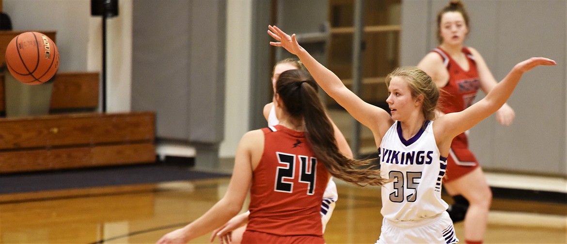 Charlo senior Carlee Fryberger defends as Noxon guard Avery Burgess passes the ball Saturday at Charlo. (Scot Heisel/Lake County Leader)