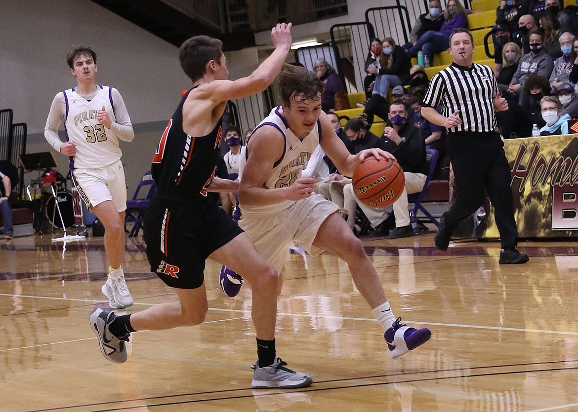 The Pirates' Jarrett Wilson drives toward a layup as the Chiefs' Zarec Couture defends Friday night at Pablo. (Bob Gunderson)