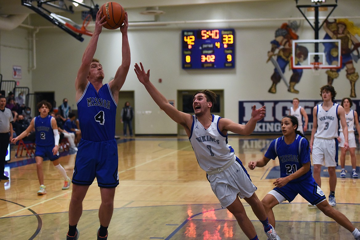 Cormac Benn lunges after a loose ball secured by Mission's Layne Spidel.

Jeremy Weber