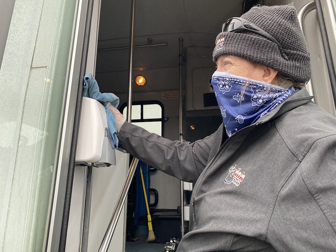 Before loading up her afternoon route, Citylink driver Teresa Parker wipes down the bus and stocks up on supplies at the Coeur d'Alene transit hub. (MADISON HARDY/Press)