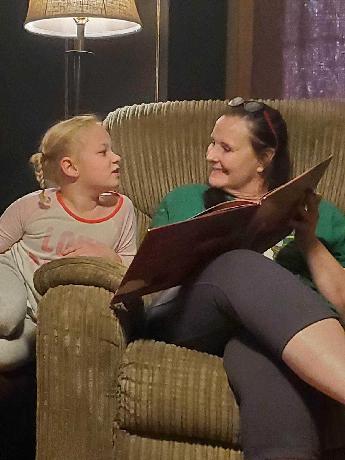 Kelli Jones is pictured reading with Rayna in this family photo.