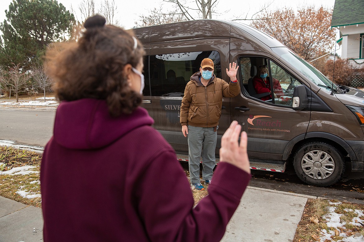 Suzan Mubarak and Mitch Domier wave goodbye after a drive-by, distanced visit outside Mubarak’s group home in Bozeman. Mubarak’s residence is only a few miles from the group home where Domier, her boyfriend, lives, yet the pandemic has limited their ability to see each other in person. (Louise Johns for KHN)